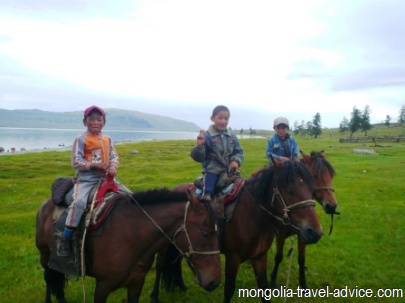 Mongolia pictures; kids on horsback